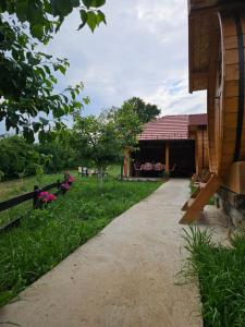 a walkway in front of a building with a yard at Kucica in Lukavac