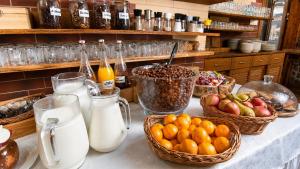 a table topped with baskets of fruit and milk at Pod Smerkami in Szklarska Poręba +28 photos