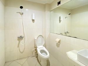 a bathroom with a shower with a toilet and a sink at Urbanview Hotel Ratna Syariah in Sukobumi +46 photos