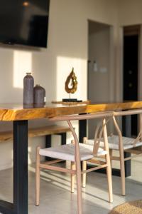 a wooden table with two chairs and a table with at Archie Paradise View in Thong Sala