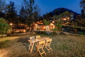a wooden table in the yard of a house at NotOnMap - H2O House in Chamba