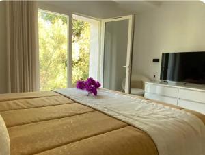 a large bed with a flower on top of it at Villa ste Catherine in Porto-Vecchio