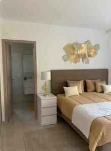a bedroom with a bed with flowers on the wall at Villa ste Catherine in Porto-Vecchio