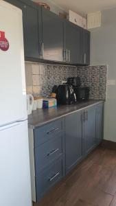 a kitchen with blue cabinets and a counter top at Wigston house in Wigston Magna