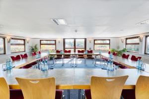 a large conference room with a long table and chairs at Schiffshotel Böttger in Dresden