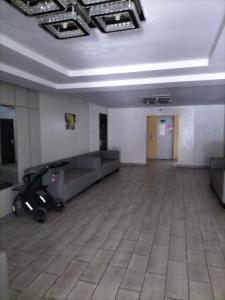 an empty room with a couch and a tile floor at Морской дом in Odesa
