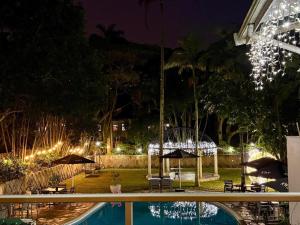a resort with a swimming pool at night at The Bay View Hotel in Richards Bay