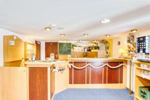 a kitchen with wooden cabinets and a counter top at Schiffshotel Böttger in Dresden +11 photos