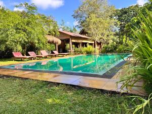 a swimming pool in the yard of a villa at The Cottage Sigiriya in Sigiriya