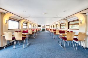 an empty train car with tables and chairs at Schiffshotel Böttger in Dresden