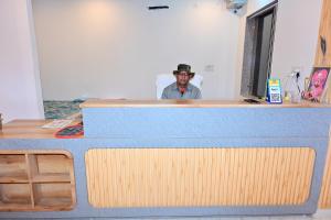 a man in a hat standing behind a counter at Hotel JR Palace- Near Toran Dwar and free Parking in Khātu