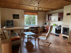 a kitchen with a table and a dining room at Agroturystyka Iwona Jażdżewska in Osława Dąbrowa