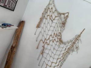 a net hanging on a wall at Guesthouse Villa Sønderklit in Skagen