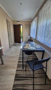 a dining room with a blue table and two chairs at Apartament u Basi in Gdańsk