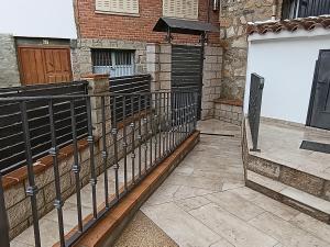 a black fence in front of a building at Casa La Rubía de Gredos in Cuevas del Valle +26 photos