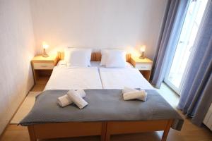 a bedroom with a bed with two pillows on it at Piadora in Banjol