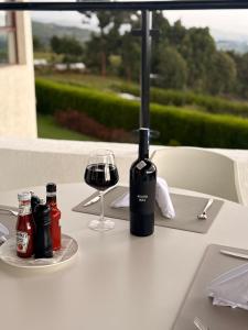 a bottle of wine and a glass on a table at Boynuz Hotels in Nyahururu
