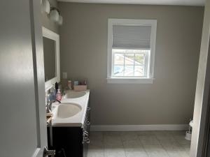 a bathroom with two sinks and a window at 12Birchwood in Holbrook +24 photos