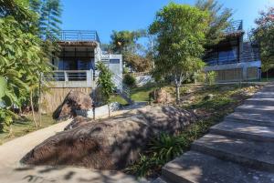 a large rock on the ground next to a building at Twelve Oclock Resort in Si Khio +14 photos