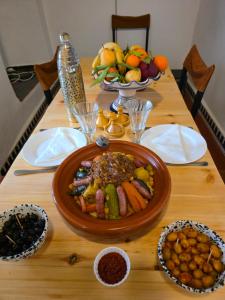 a wooden table with a plate of food on it at Riad Patio des Amis Marrakech in Marrakesh +14 photos