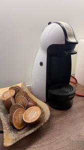 a coffee maker next to a plate of chocolates at Baklava in Sarajevo +5 photos