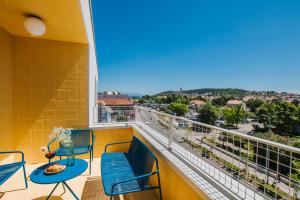a balcony with chairs and a view of the city at áPero Suites in Trogir