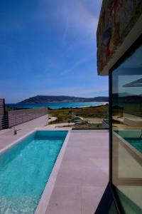 a view of a swimming pool from a house at Relaxury Villa II in Karpathos