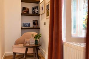a room with a chair and a table and a window at Europe Hotel Paris Eiffel in Paris +47 photos