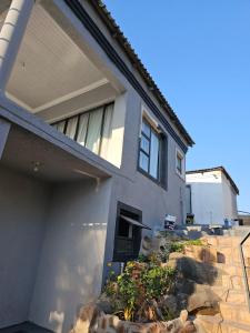 a house with a stone staircase leading up to it at Mgwenya Capsule Hotel in Nelspruit
