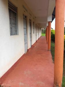 an empty hallway of a building with orange columns at Yasipi Cottages in Sipi