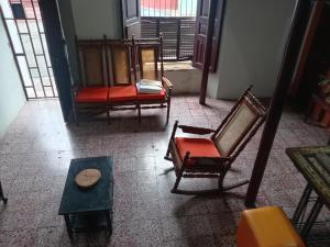 a room with chairs and a table and a window at "Casa de Piobeto" in Santa Ana