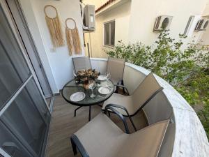 a small balcony with a table and chairs on a patio at Sunny hill Apartment in Golem