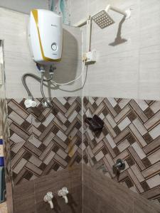 a bathroom with a shower with a shower head at ADwarkesh femily homestay in Dwarka