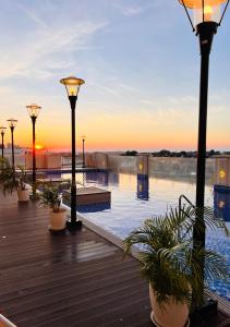 a pool with lights and potted plants on a boardwalk at RR 21 Milan Residenze Fairview in Manila