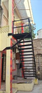 a spiral staircase on the side of a building at ADwarkesh femily homestay in Dwarka