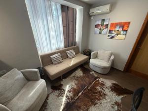 a living room with a couch and a chair at Sunny hill Apartment in Golem
