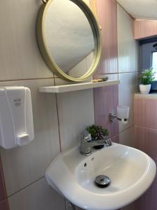a bathroom with a sink and a mirror at Ada's House 2 in Mytikas +41 photos