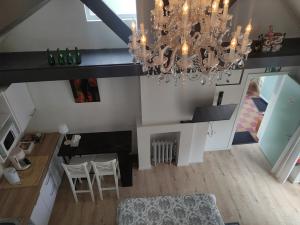 an overhead view of a kitchen and dining room with a chandelier at Huma2025 in Eede +16 photos