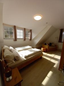 a bedroom with a large bed in a attic at Ferienhaus Buschmuehle - Stolpen in Stolpen