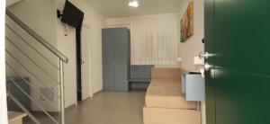 a hallway with a green door and stairs in a house at Le Casette Del Mare in Crotone +38 photos