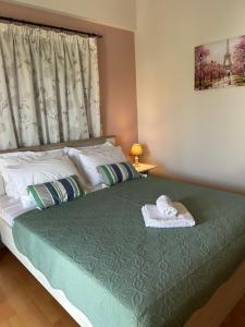 a bedroom with a bed with a hat on it at Ada's House 2 in Mytikas