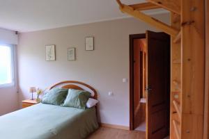 a bedroom with a bed and an open door at El Cimblu in Gradura