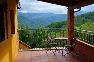 a balcony with two chairs and a table with a view at El Cimblu in Gradura
