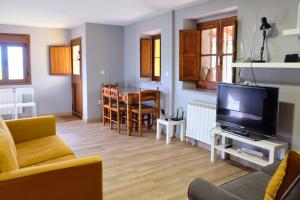 a living room with a couch and a television at El Cimblu in Gradura