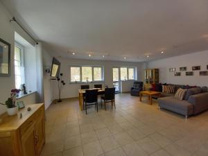 a living room with a couch and a table at Ferienhaus Buschmuehle - Stolpen in Stolpen