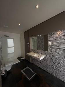 a bathroom with a sink and a toilet and a mirror at Aqua Ria Boutique Hotel in Faro +52 photos