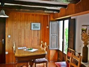 a dining room with a wooden table and chairs at Casa amb terrassa i vistes a la vall - Cal Taverner in Montsonis +24 photos
