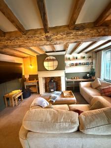 a living room with a couch and a fireplace at Rustic Retreat cottage in Thirsk