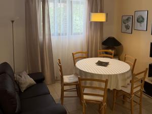 a living room with a table and a couch at MAG Apartmani in Jezera