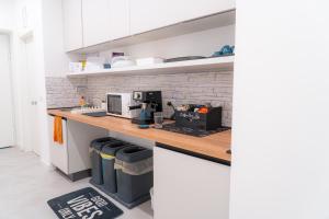 a kitchen with a counter with a computer on it at Mythos House in SantʼAgata sui Due Golfi